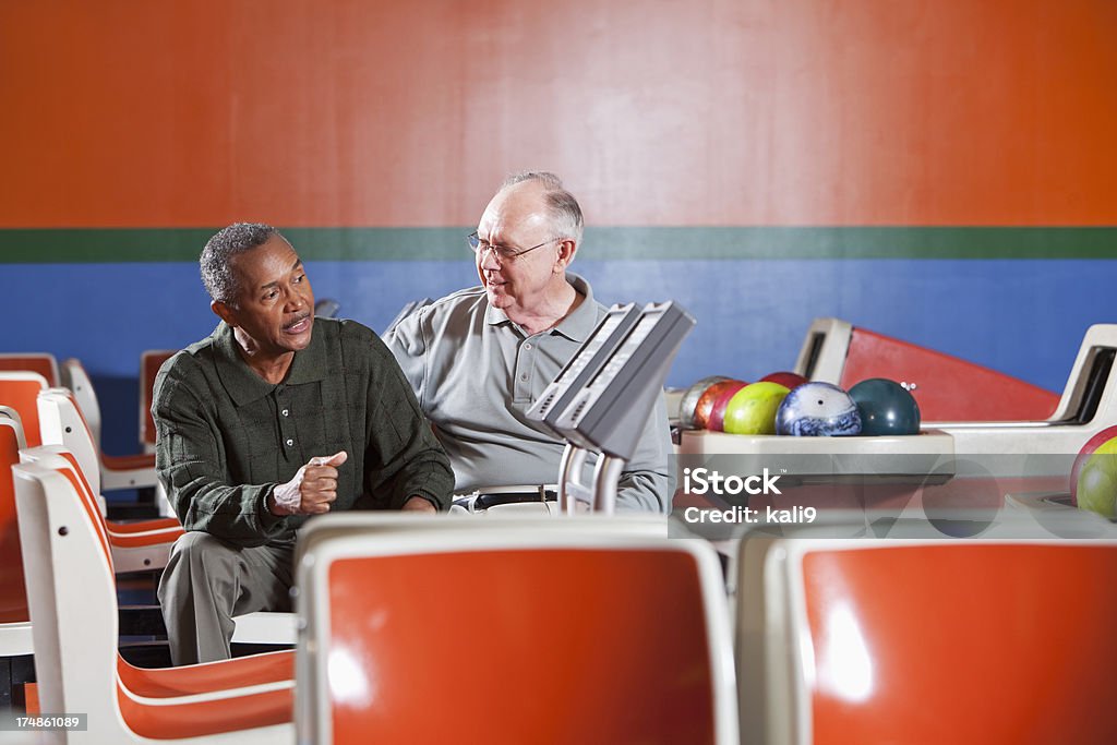 Senior hommes discuter de bowling - Photo de 60-64 ans libre de droits