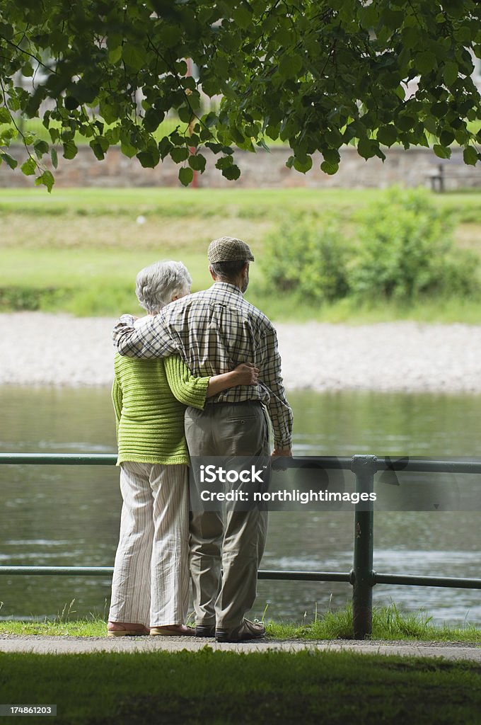 Senior couple by a river Senior couple relaxing by a river. 70-79 Years Stock Photo