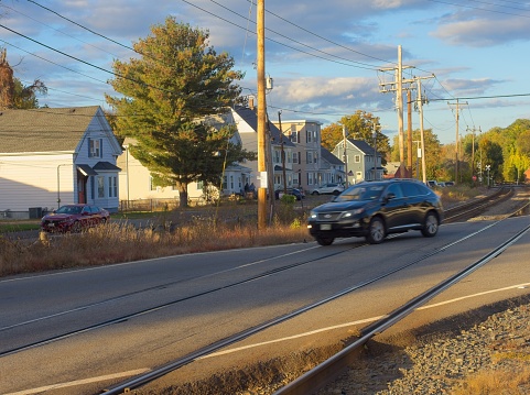 North Andover, Massachusetts - USA, October 19, 2023. Car travels along busy intersection over train tracks near downtown North Andover Massachusetts.