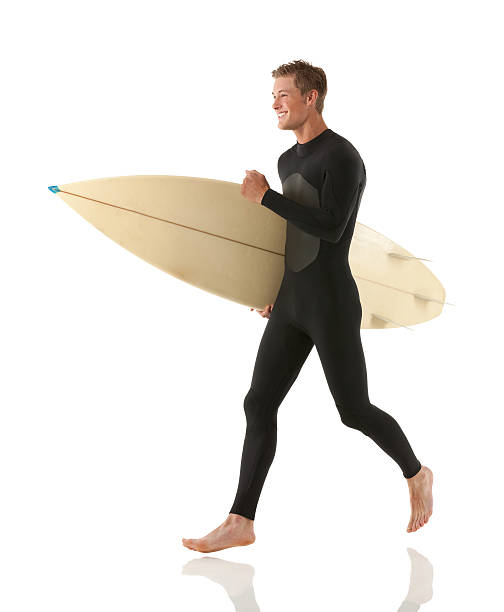 istock Male surfer carrying a surfboard 174861256
