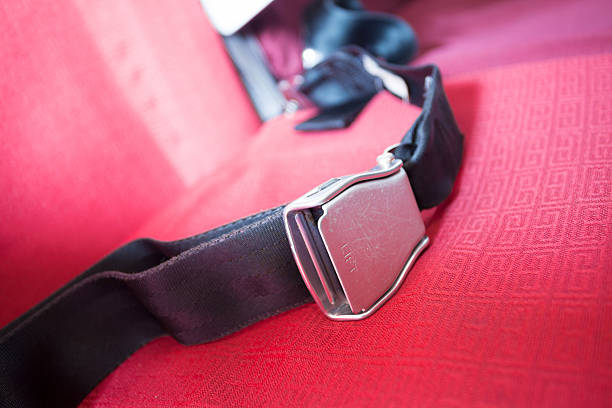 istock seat belt with red background shot in airplane 174861308