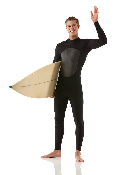 istock Smiling male surfer standing with a surfboard 174861667