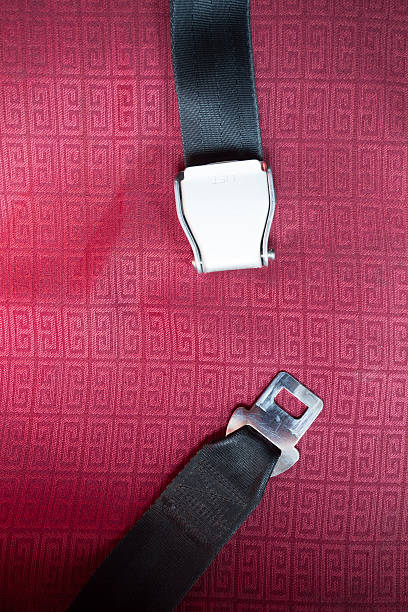 istock seat belt with red background shot in airplane 174861678