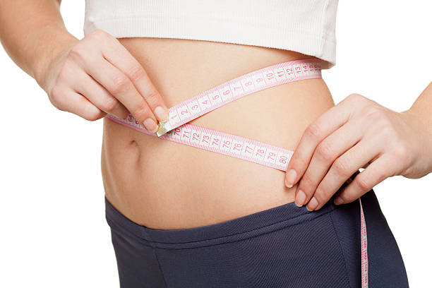 istock Woman measuring her waist 174861987