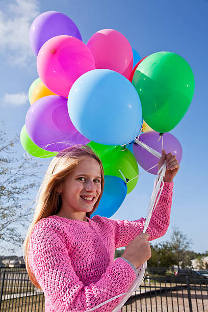 istock Girl holding balloons 174862075