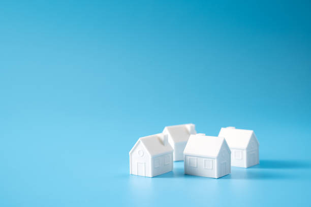 istock Miniature 3D printed model house on blue background 1748623121
