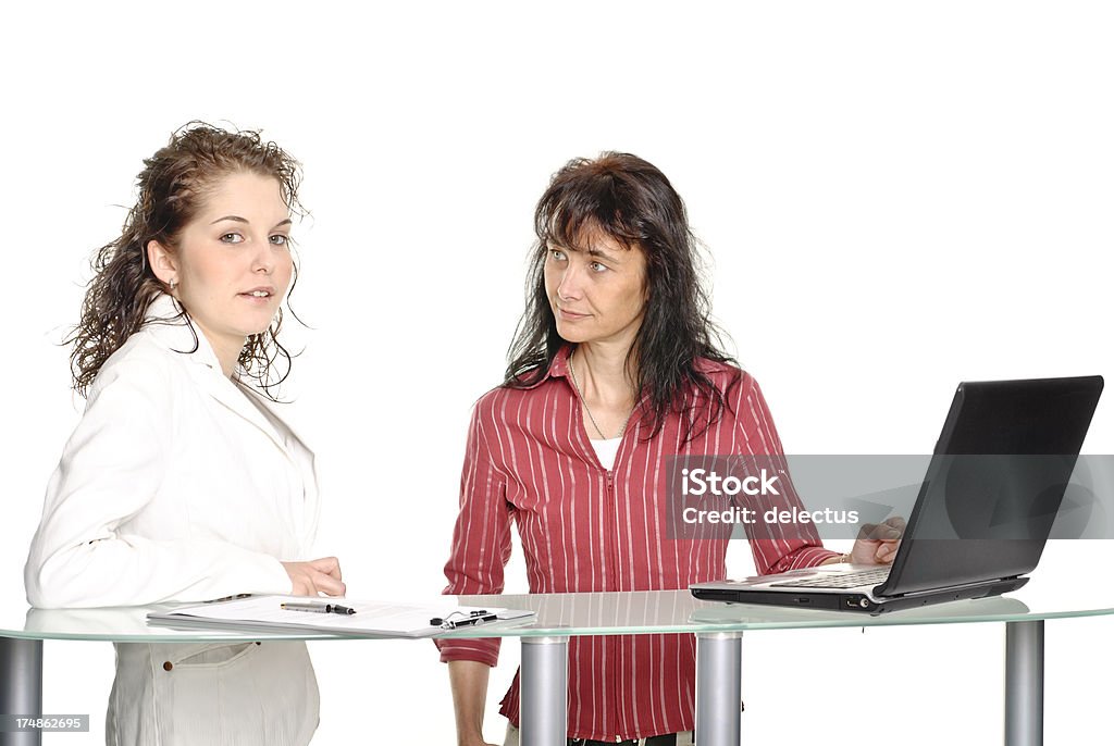 Two women in the consultation Two women in the consultation. At a high glass table with laptop. Adult Stock Photo