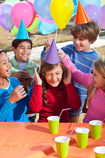 Multi-ethnic children (7-10 years) having fun at birthday party.