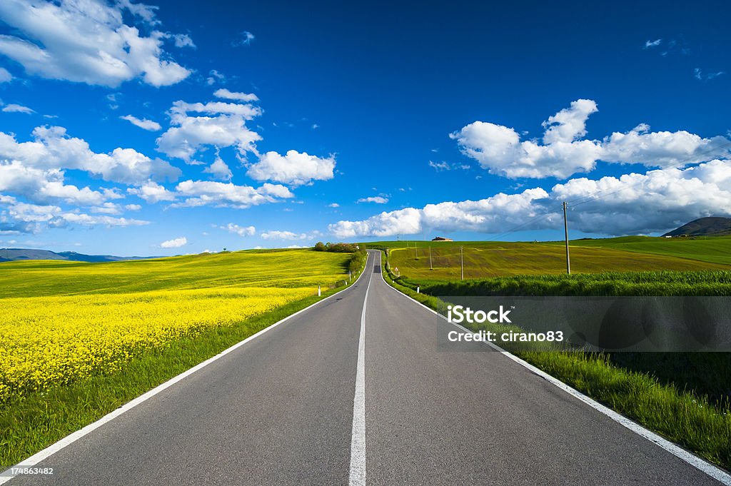Road in the nature Road in Tuscany, Val d'orcia, during a sunny day. Italy Stock Photo