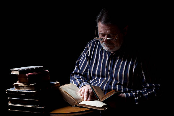 istock Portrait of Old Man With Reading Book 174863541