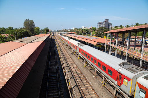 This image features Madgaon Train Station, a key railway hub located in Goa, India. As one of the busiest stations in the region, Madgaon serves as a vital link connecting various parts of Goa with other Indian cities. The station is equipped with modern amenities yet retains architectural elements that reflect local Goan culture. The photograph aims to capture the station's bustling atmosphere, highlighting the mix of travellers, from tourists exploring Goa's beaches to locals commuting for work. With its platforms, ticket counters, and tracks serving as focal points, the image offers a comprehensive view of this important transportation node, portraying it as a microcosm of life in Goa.