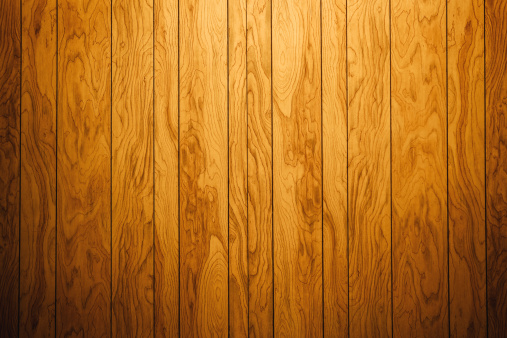 A dramatically lit retro wood paneled wall, ready to be used as a design element or placed behind your isolated image/text as a background. Horizontal with copy space.