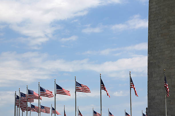 istock America Flags and Washington Monument 174864531