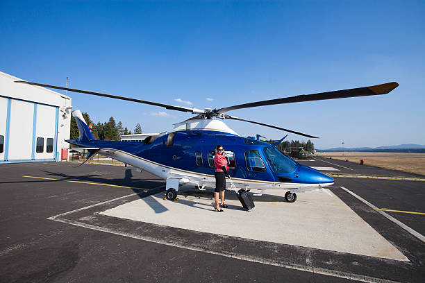 istock Young business woman waiting for flight with helicopter 174864763