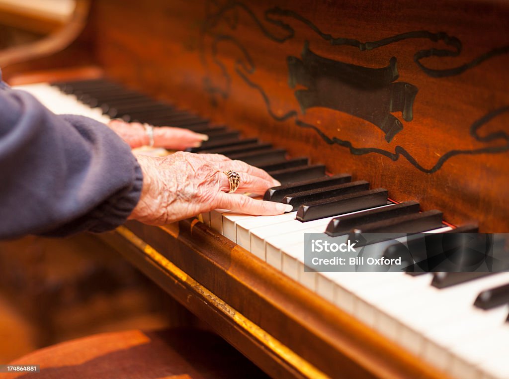 Playing Piano Elderly woman playing piano Piano Stock Photo