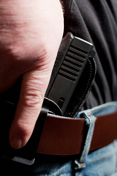 istock Concealed Carry Firearm Drawn From an Inside-the-Waistband Holster 174865293