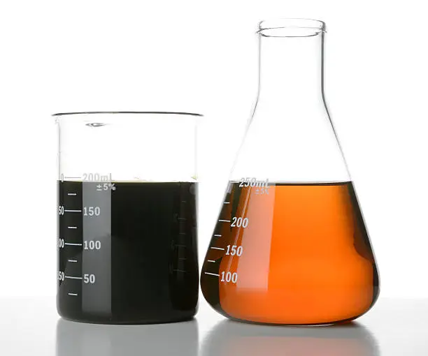 Photo of New and Used Motor Oil in Laboratory Glassware