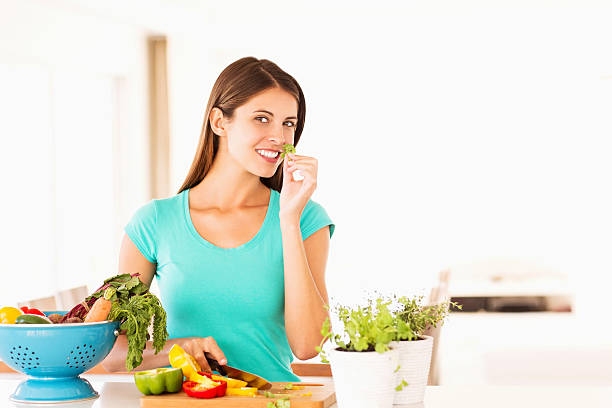 istock Woman Smelling Parsley Leaves In Kitchen 174865651