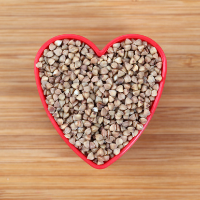 Buckwheat in a heart bowl. Close-up.Please see lightbox: