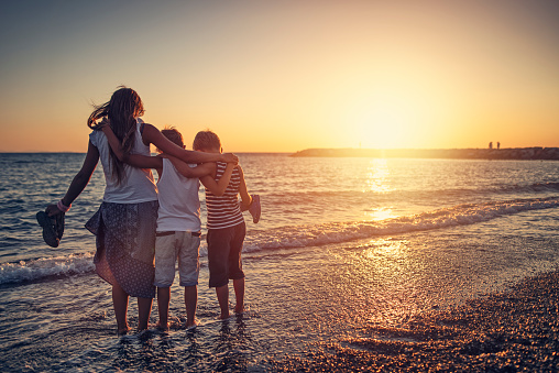 Three kids wading in the sea on the beautiful sunset.
Shot with Nikon D810