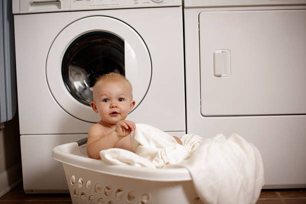 istock Baby boy playing in laundry basket 174866049