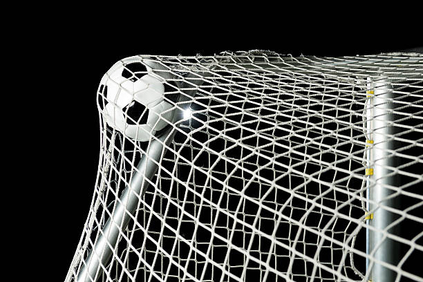 istock Soccer ball hits the net at stadium 174866332