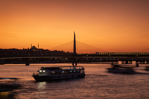 Ferries and boats in Golden Horn Bay at sunset, Istanbul, Turkey