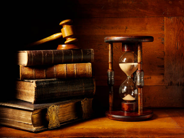 Antique Books with a Magnifyng Glass and Hourglass stock photo