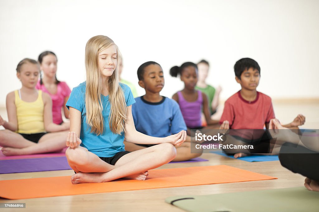 Kids Yoga Kids doing yoga and meditating 10-11 Years Stock Photo