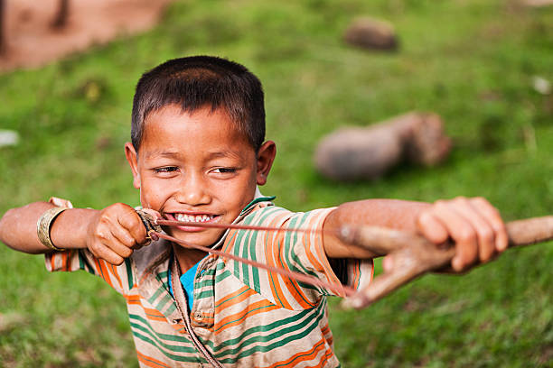 istock Young boy with slinghshoot in Northern Laos 174867065