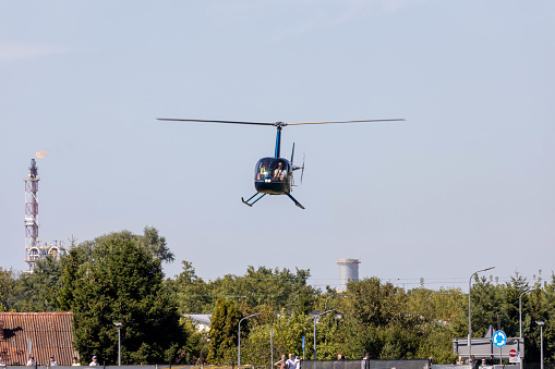 Hoovering helicopter. Blue sky.