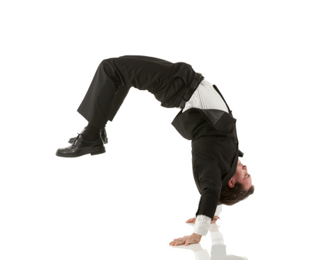 Businessman performing cartwheel