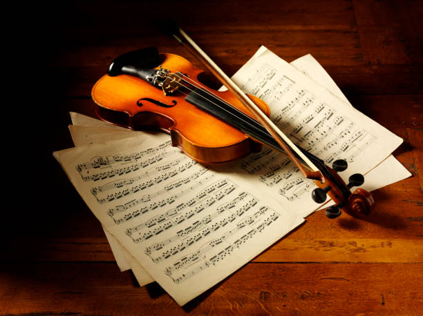 istock Old Sheet Music and a Violin 174867840