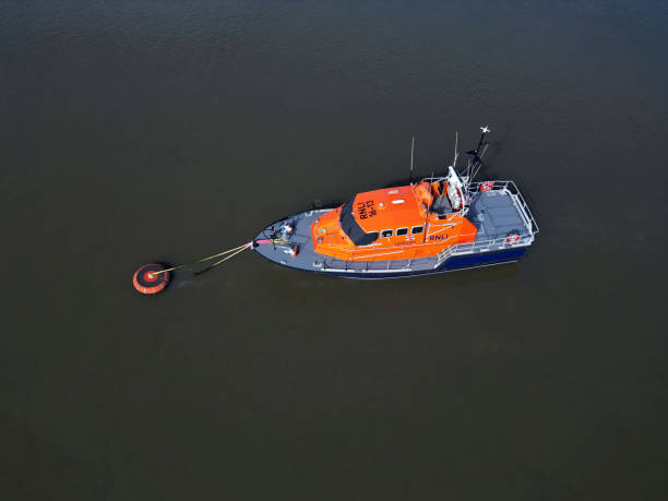 istock Orange Lifeboat mooring in dark water 1748678503