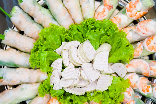 Top view of Vietnamese rice noodle vegetable shrimp rolls with sliced sausage