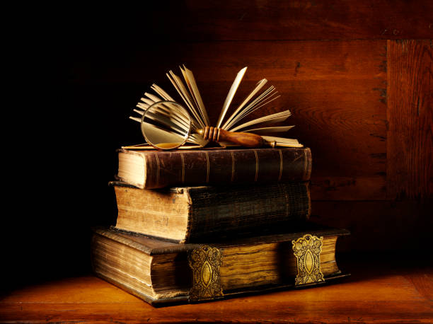 istock Antique Brown Hardback Books in a Pile 174868476