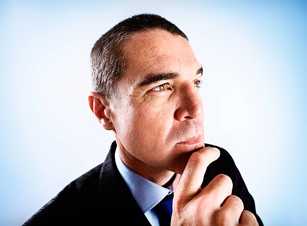 istock Handsome business executive thinking things over, hand on chin 174868976