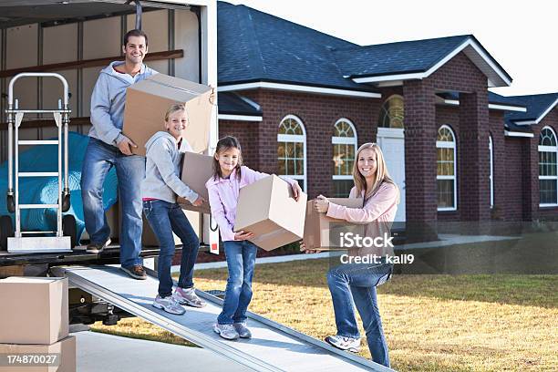 Family Moving House Unloading Truck Stock Photo - Download Image Now - Moving Van, In Front Of, Looking At Camera