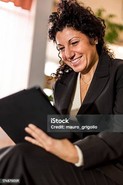 Businesswoman Using A Digital Tablet Stock Photo - Download Image Now - 30-39 Years, 40-49 Years, 50-59 Years