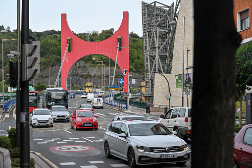 Getxo, Spain, October 16, 2023 - The La Salve Bridge in Bilbao with the red arches by Daniel Buren.
