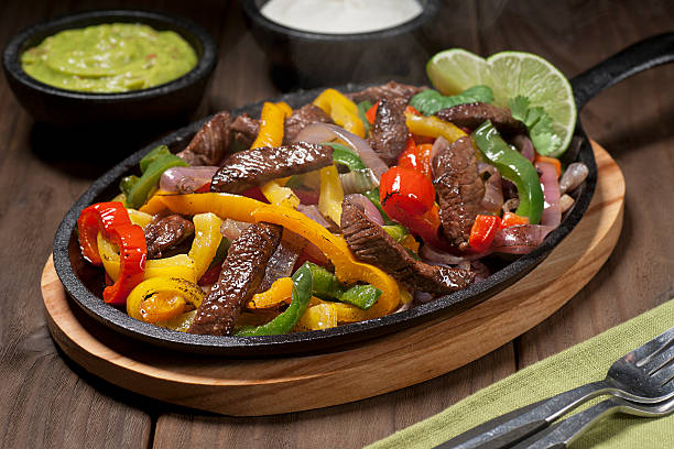 istock Beef fajitas in a skillet on a wooden table 174870687