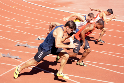 four athletes powerful start training on tartan track