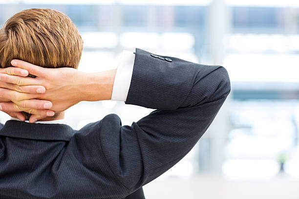 istock Businessman Relaxing With Hands Behind Head 174870766