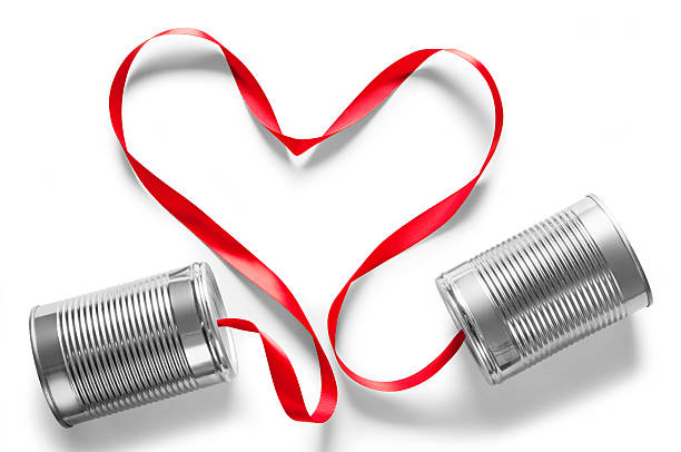 istock Tin can telephones connected with heart shaped ribbon 174871003
