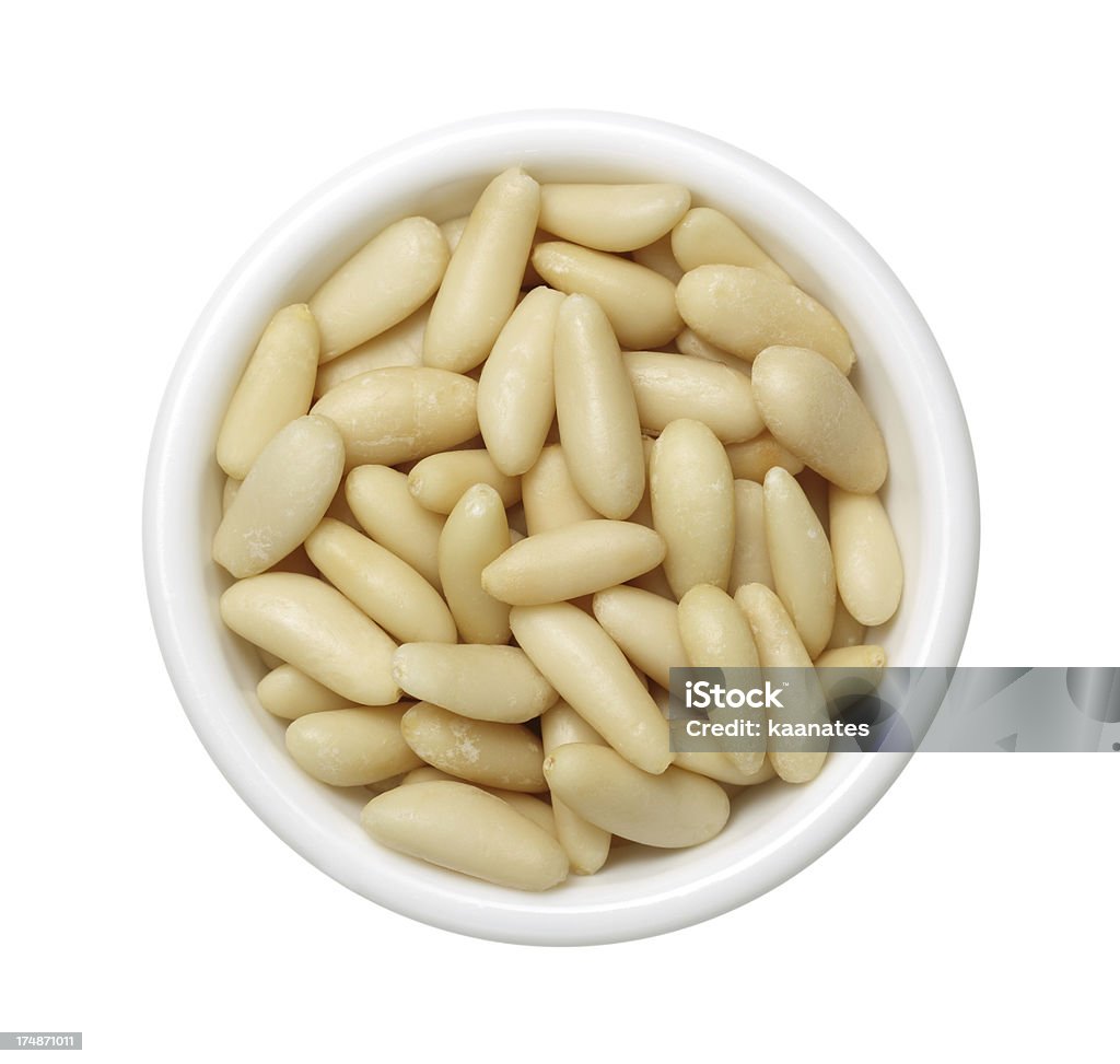 Pine nuts Top view of white bowl full of Pine nuts Pine Nut Stock Photo