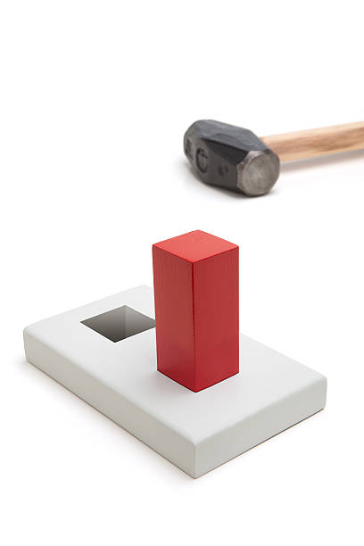 Square peg fitting in a hole stock photo