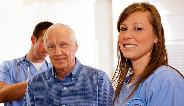 istock Medical: Senior man being checked by doctor, nurse in foreground 174871467