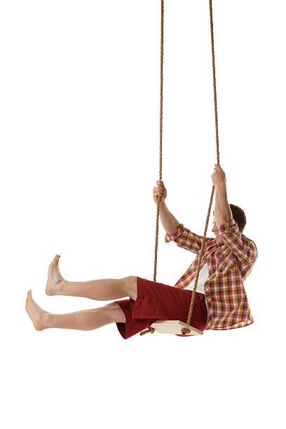 istock Man swinging on a rope swing 174871504