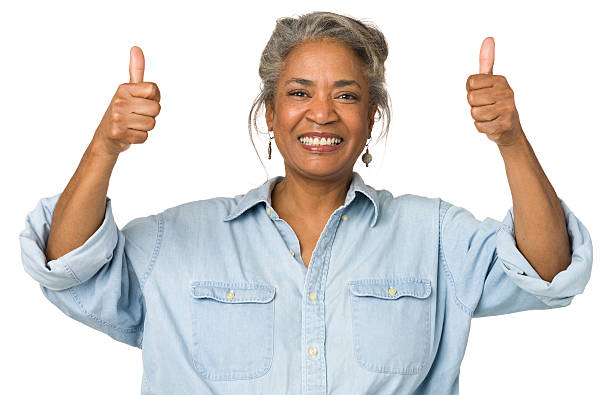 Mature Woman Gives Two Thumbs Up Portrait of a mature woman on a white background. exhilaration photos stock pictures, royalty-free photos & images