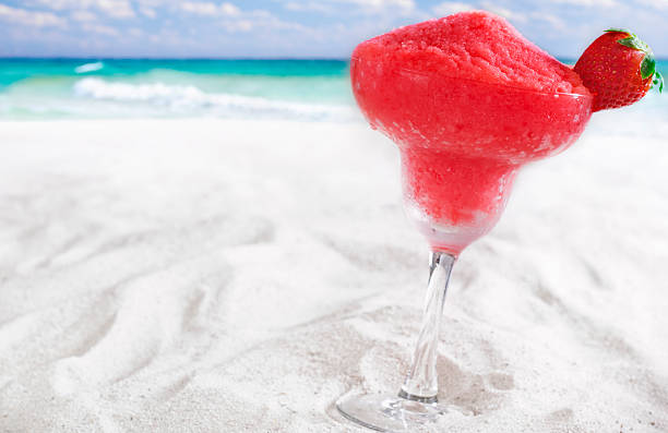Strawberry Daiquiri Strawberry daiquiri on the beach.  Please see my portfolio for other food and drink related images. fruit garnish stock pictures, royalty-free photos & images